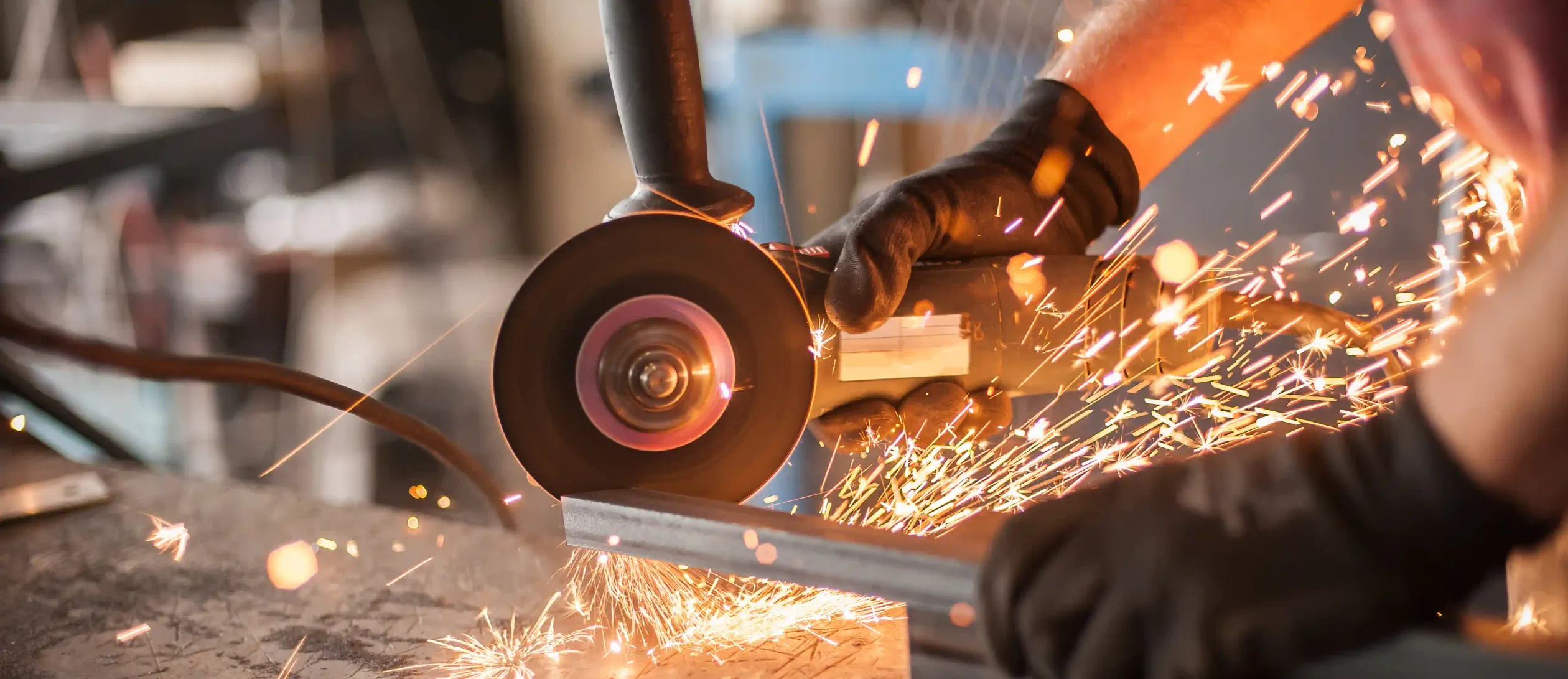 An angle grinder cutting metal with sparks