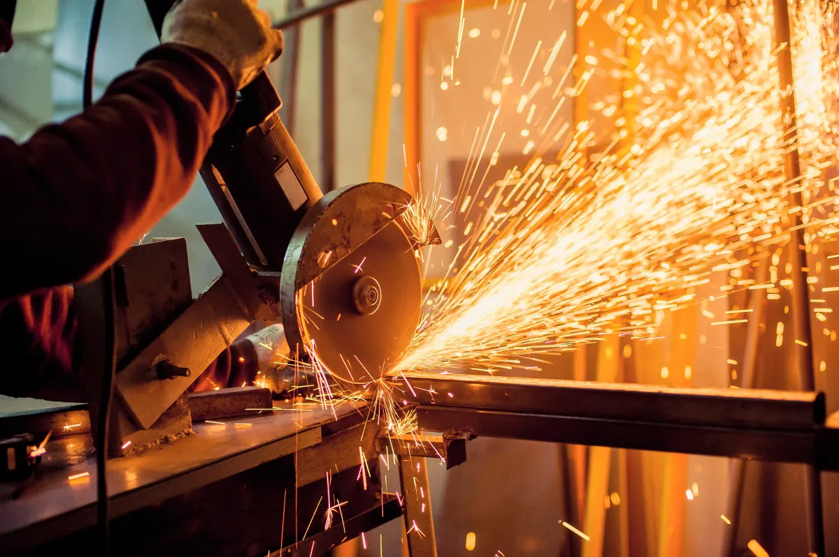 Sparks from an angle grinder cutting a steel beam